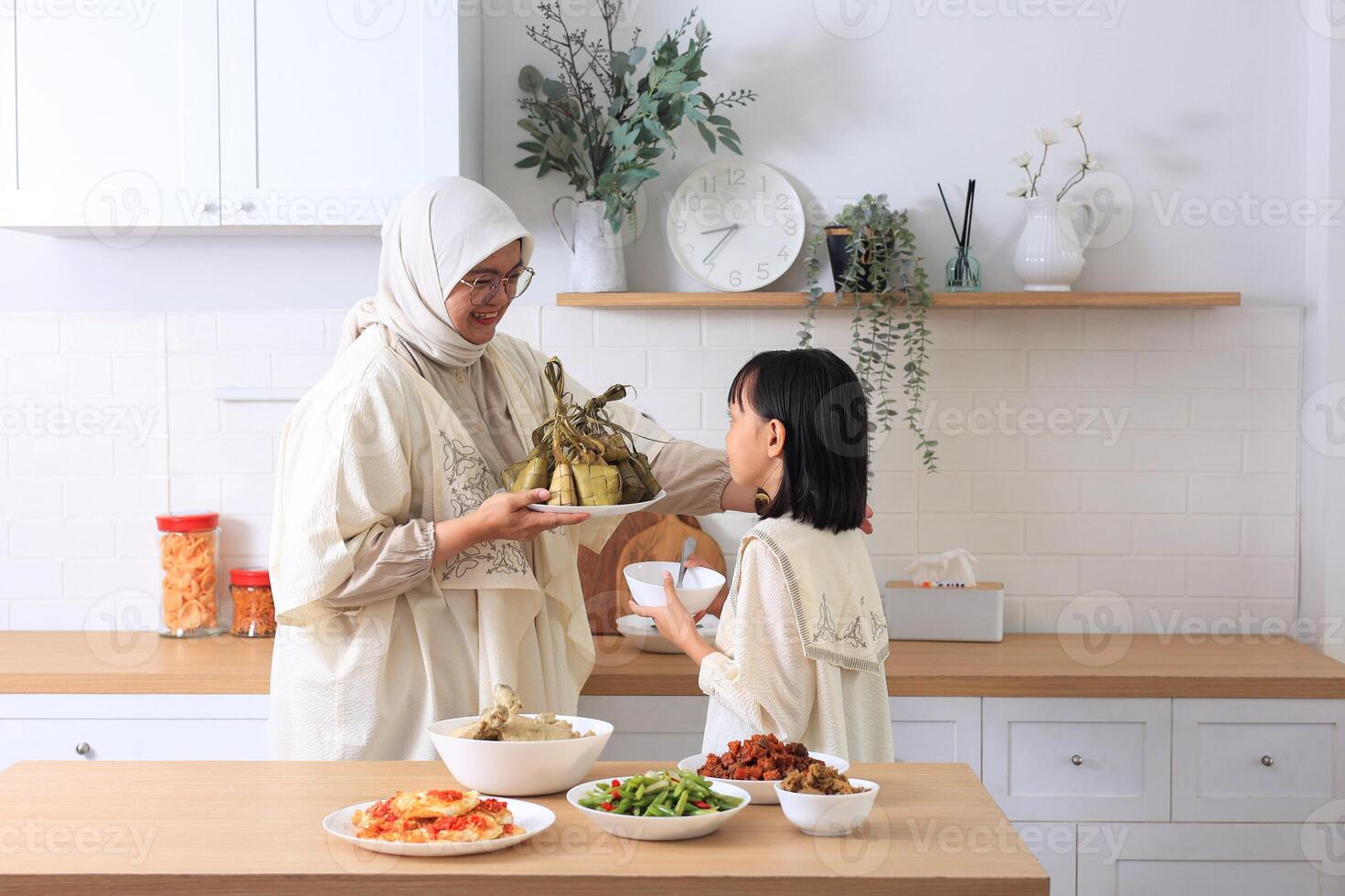 Mom and Kids Preparing ketupat Lebaran for Eid Al Fitr Celebration in the Kitchen photo