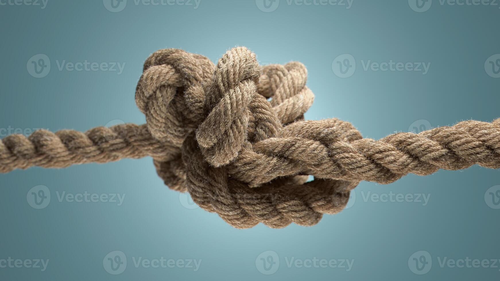 Tightly Bound. A Knot of Natural Rope Against a Serene Blue Background photo