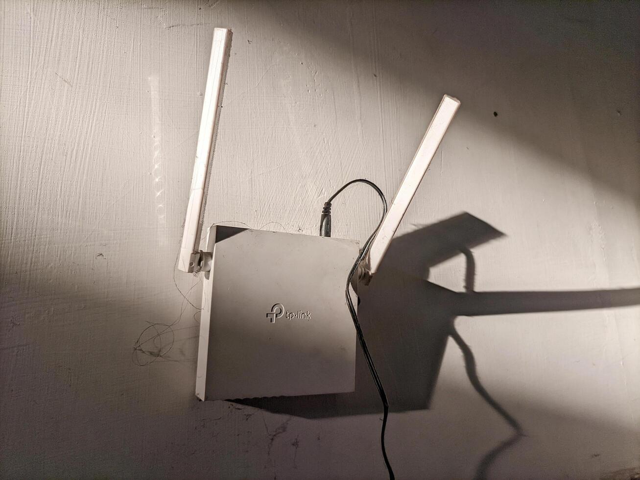Medan, Indonesia 24 January 2025 - Internet router hanging on the wall, Wi-Fi modem at home and in the office. photo