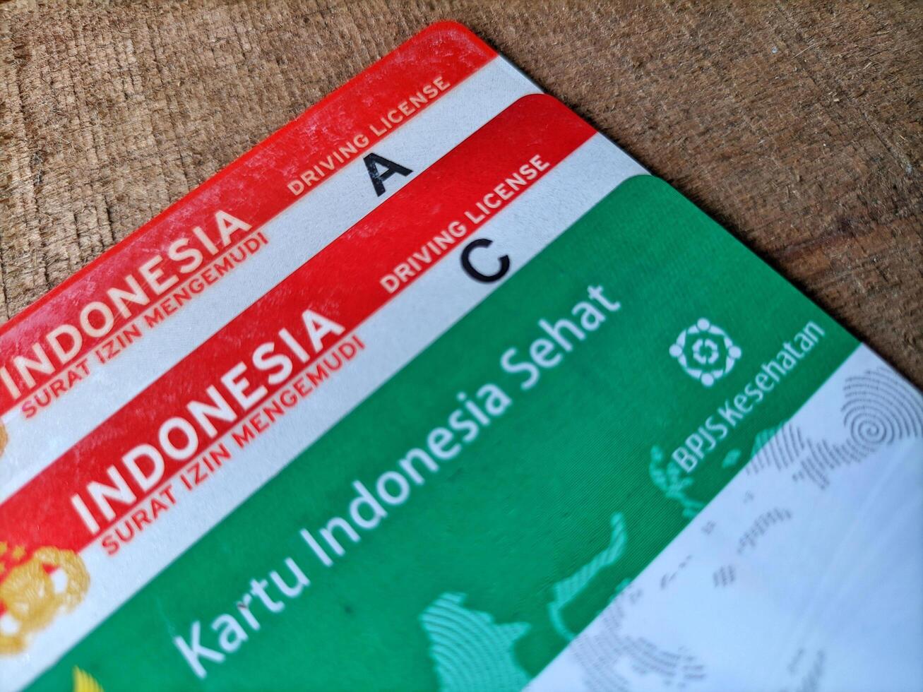 Medan, Indonesia January 22 2025 - Close up of the Healthy Indonesia Card or BPJS Kesehatan and Driving License Sim A and Sim C. photo