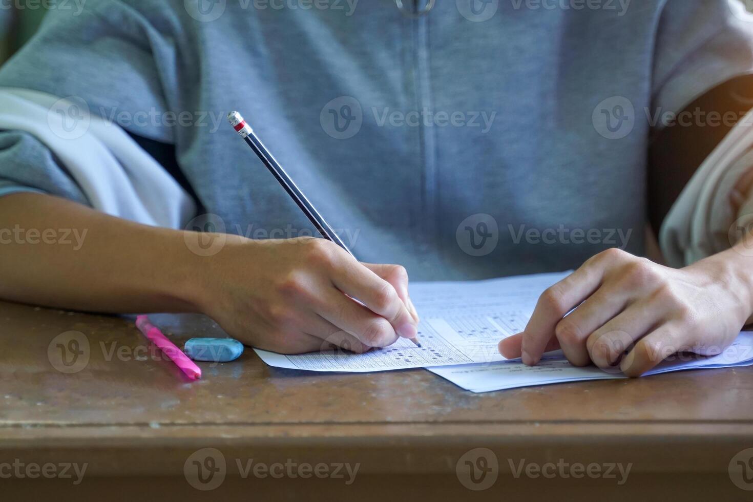 students are taking exams to measure learning in the classroom. Soft and selective focus. photo