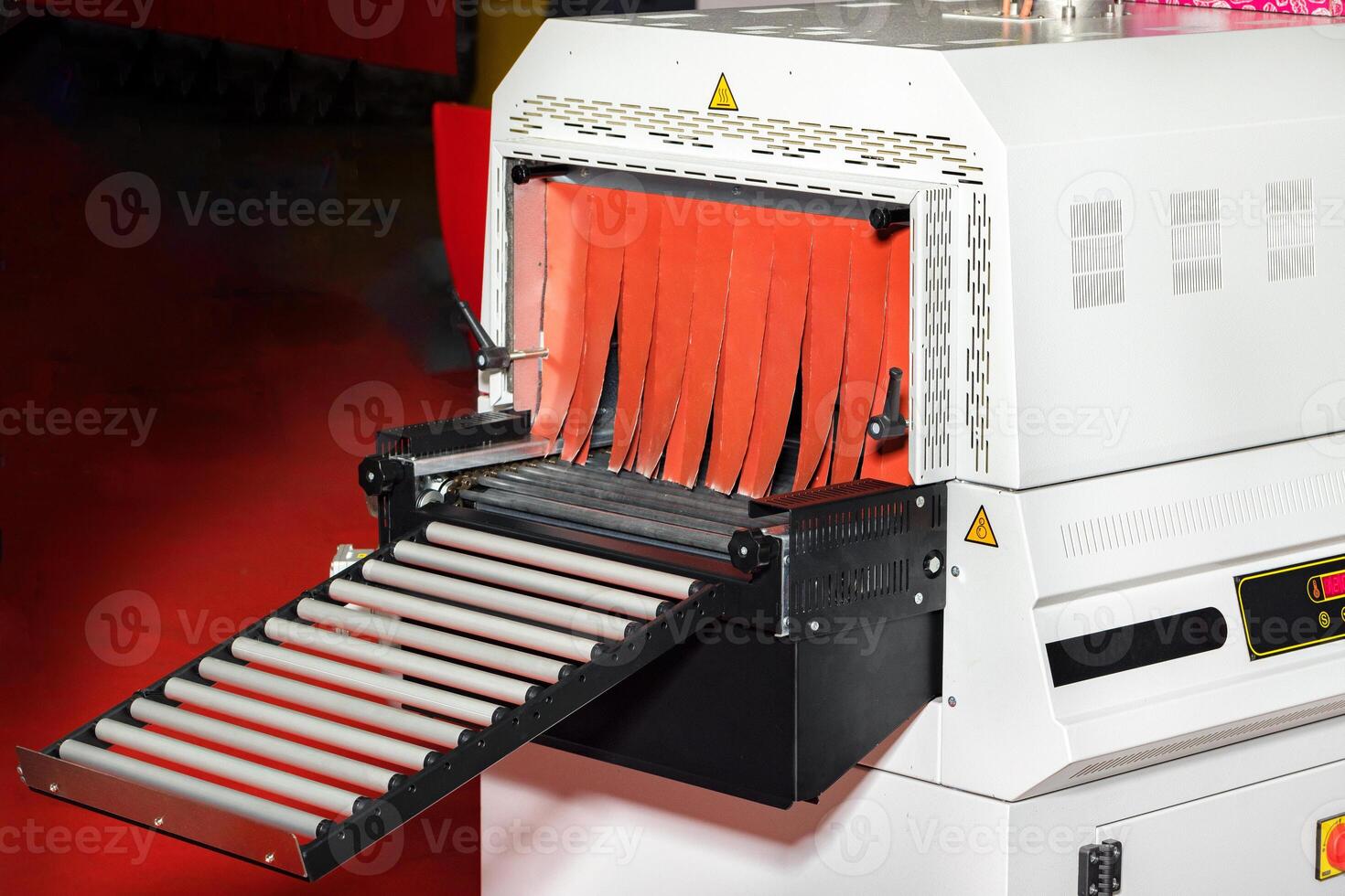 Fragment of a tunnel mini-shrinking machine for packaging food products. photo
