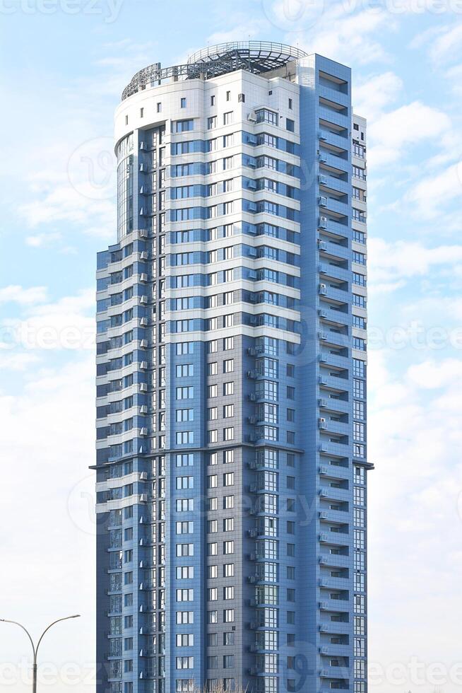 Architecture of a modern residential high-rise building on a sunny day. photo