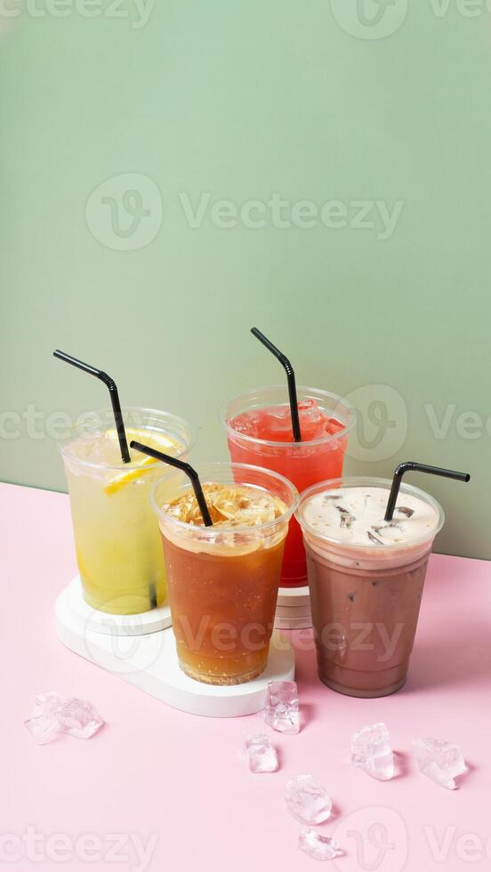 Colourful summer drinks with ice. Lemonade on colored background photo