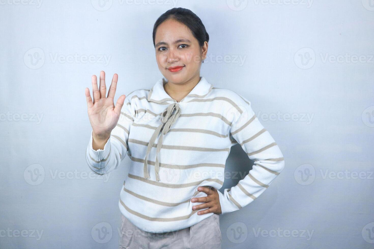 Beautiful asian young woman wearing sweater showing fingers number five while smiling confident photo