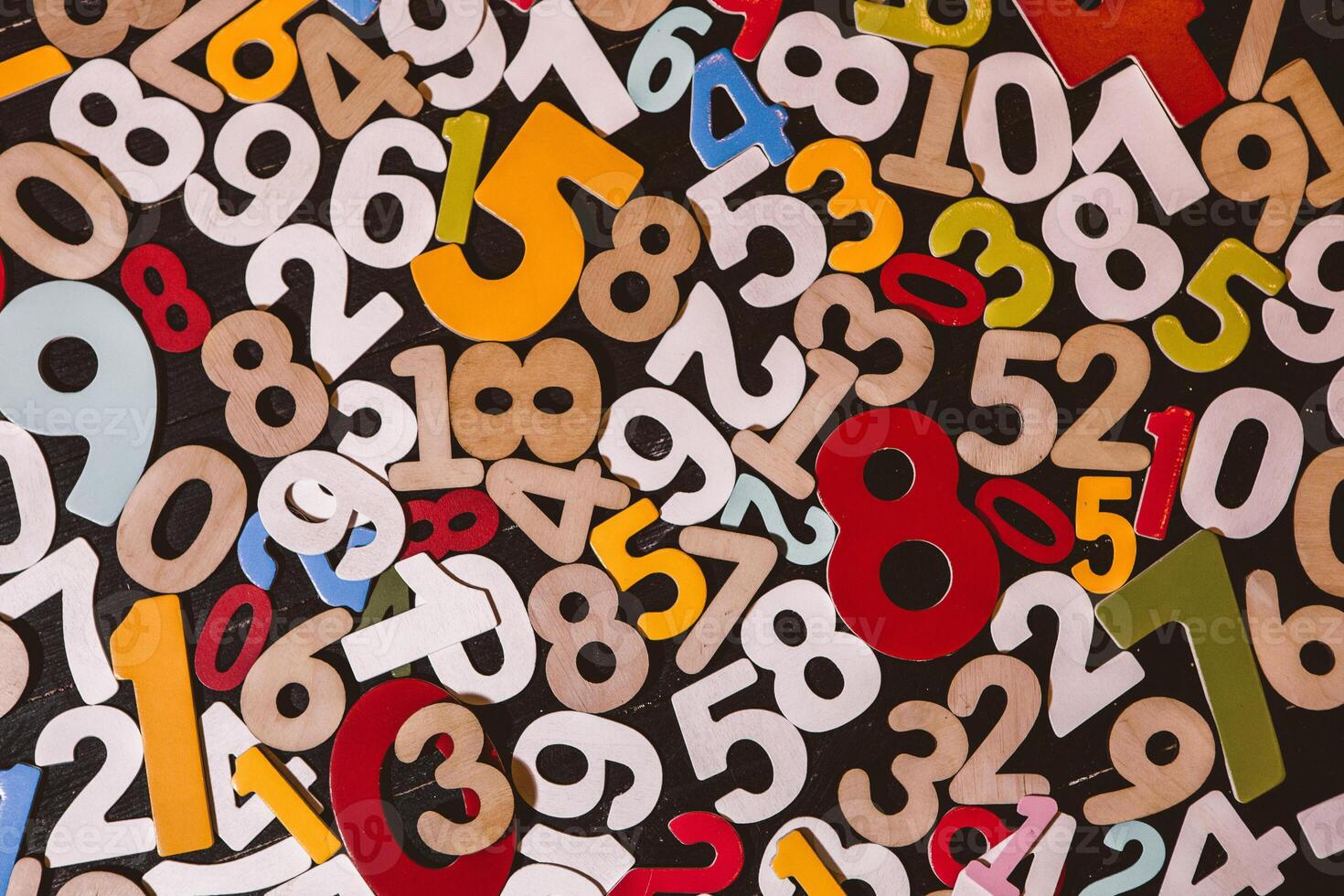 Pile of wooden numbers on black background with filter effect retro vintage style photo