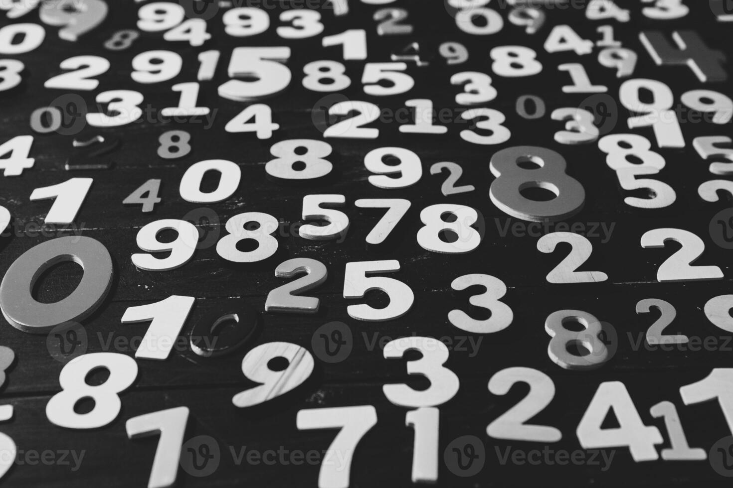 Numbers on a dark wooden background. Black and white. Close-up. photo