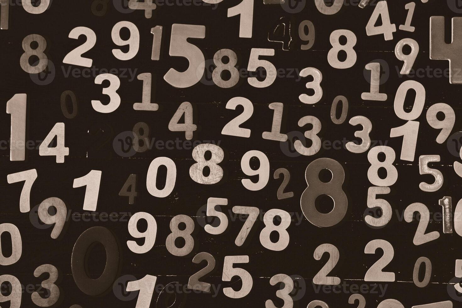 Numbers on a black wooden background, close-up, toned photo