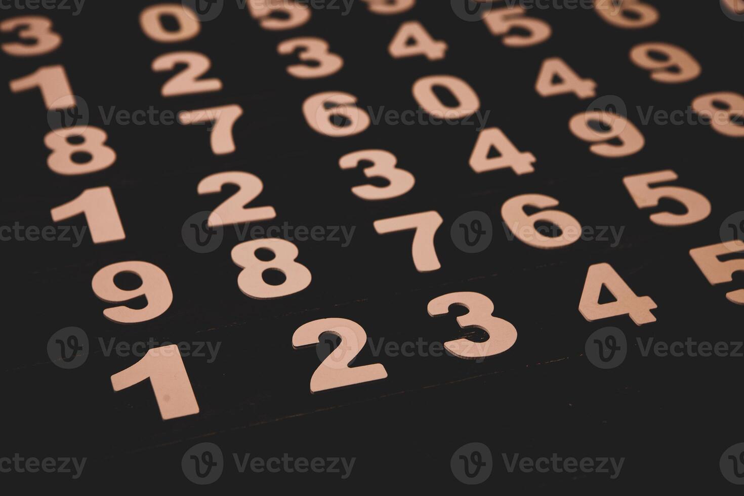 Wooden numbers on a black background. Numbers are laid out in the form of figures. photo