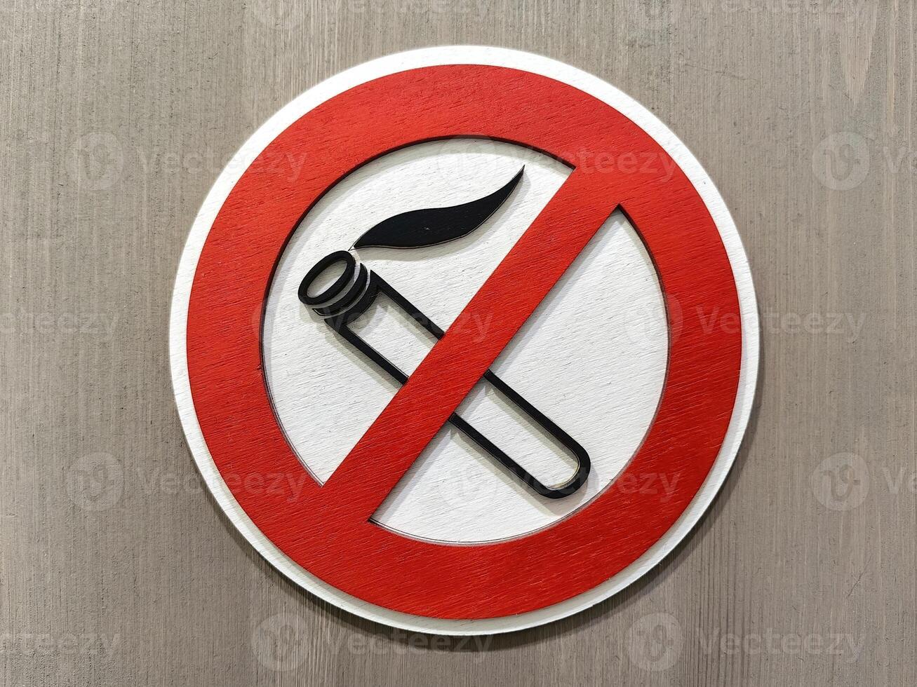 Close up of no smoking sign displayed on a wooden wall emphasizing the importance of a smoke-free environment photo