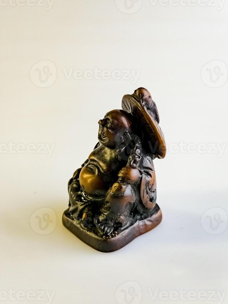 Figurine of a funny, laughing and cheerful golden copper Buddha or Hotei. Concept of luck, prosperity and Chinese god of wealth photo
