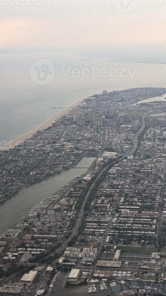 View of New York from an airplane. Haze. Vertical. View from the porthole photo
