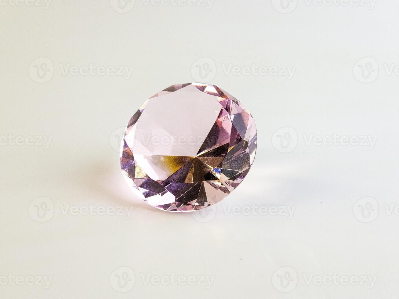 Pink crystal crystal on a white background. Close-up. Transparent stone photo