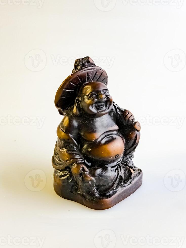 Figurine of a funny, laughing and cheerful golden copper Buddha or Hotei photo
