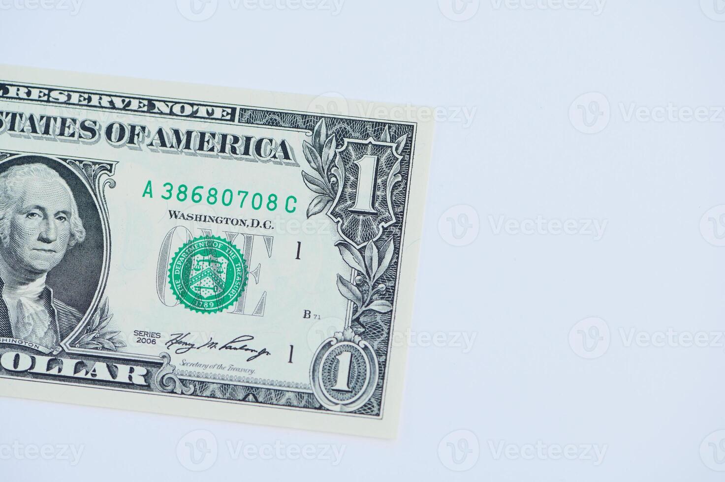 One dollar bill placed on a clean white background highlighting its design and details photo