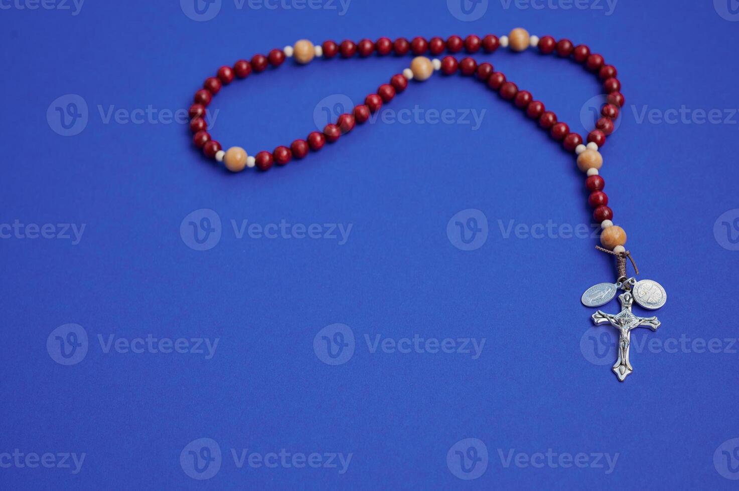 Rosary beads on a blue background for prayer and meditation experience photo