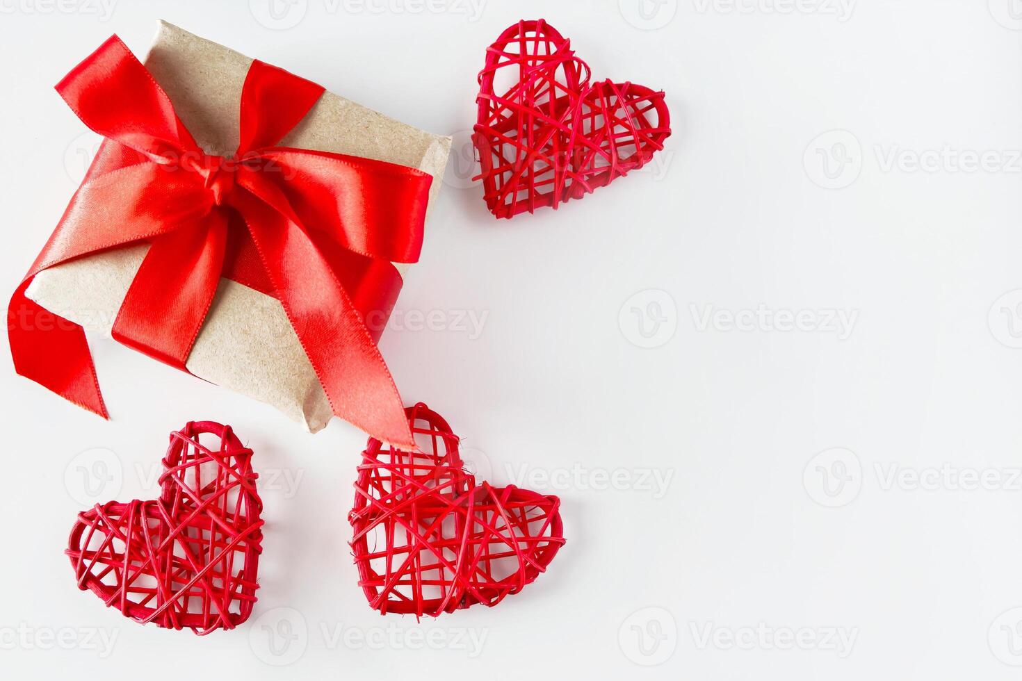 Valentines day gift and red hearts on white background. Copy space photo