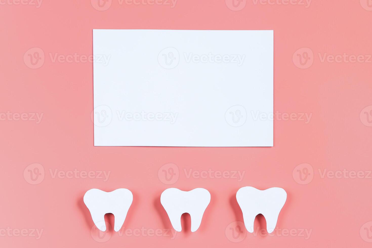 Paper cut tooth mockup and greeting card on pink background. Happy dentist day. photo