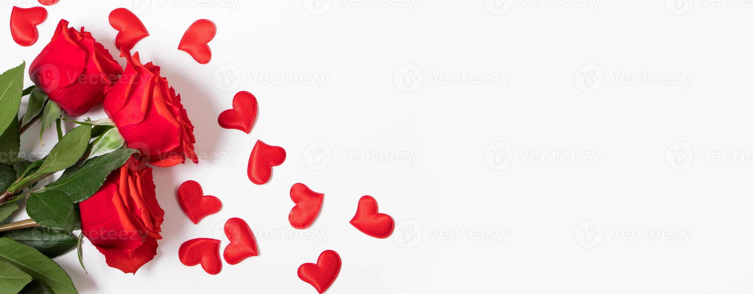 Red roses and hearts on white background. Valentine's day greeting card. Place for your text. photo