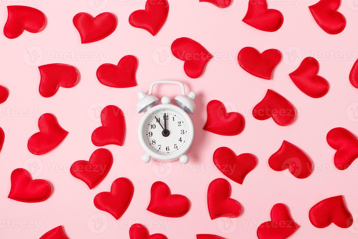 Time for love. Alarm clock and red hearts on a pink background. Valentine's day concept, banner format photo