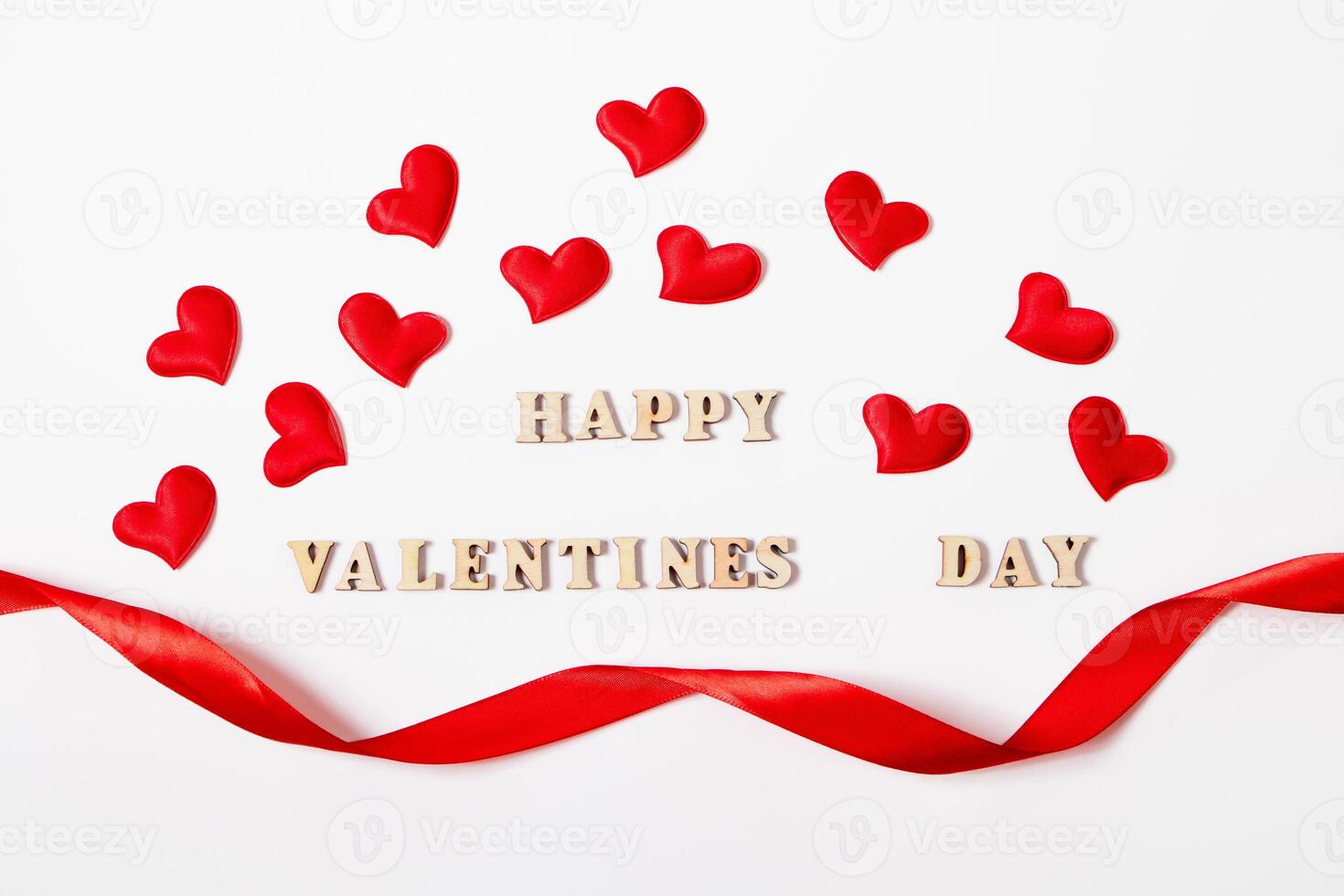 Red hearts and the inscription Valentines Day on a white background. Lovers' holiday concept, greeting card. photo