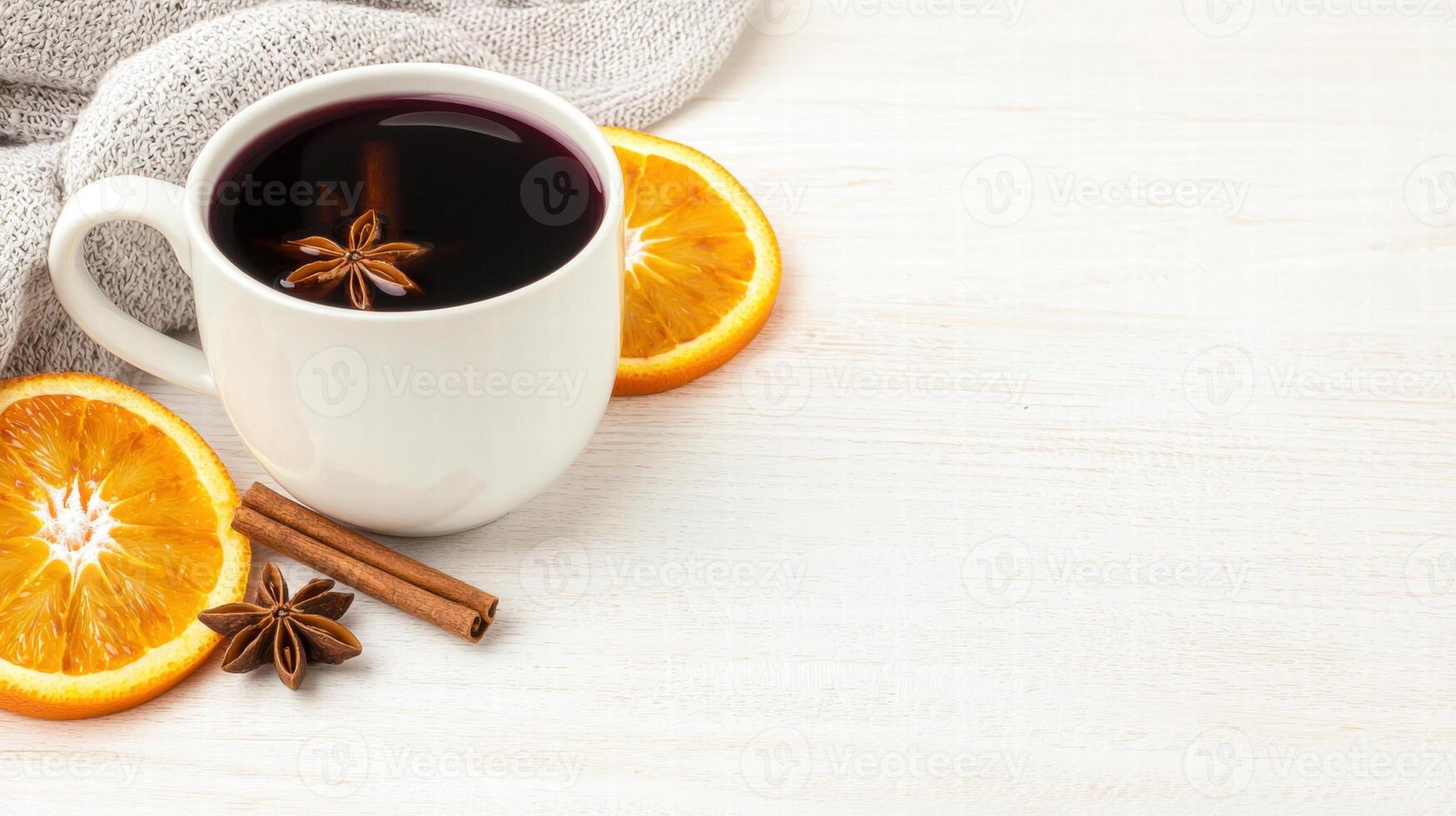 A cozy cup of spiced coffee sits beside fresh orange slices and cinnamon sticks, perfect for a warm, aromatic experience. photo