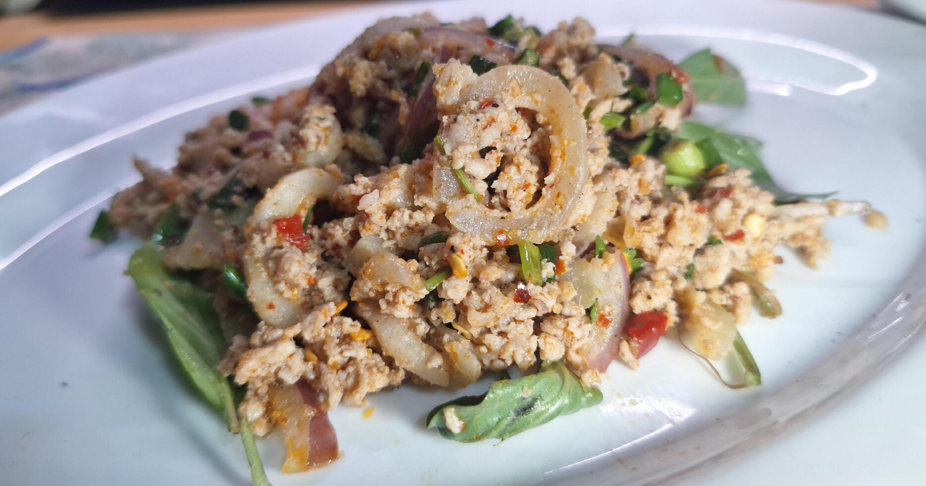 Minced pork larb with vegetables. Local Thai food. photo