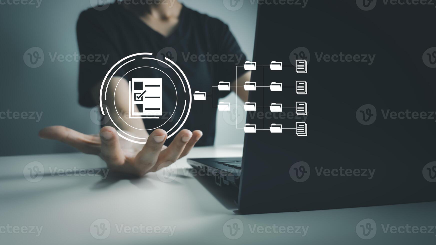 Document Management System, Officer using laptop manage files, Online document database management, automated processes to manage system photo