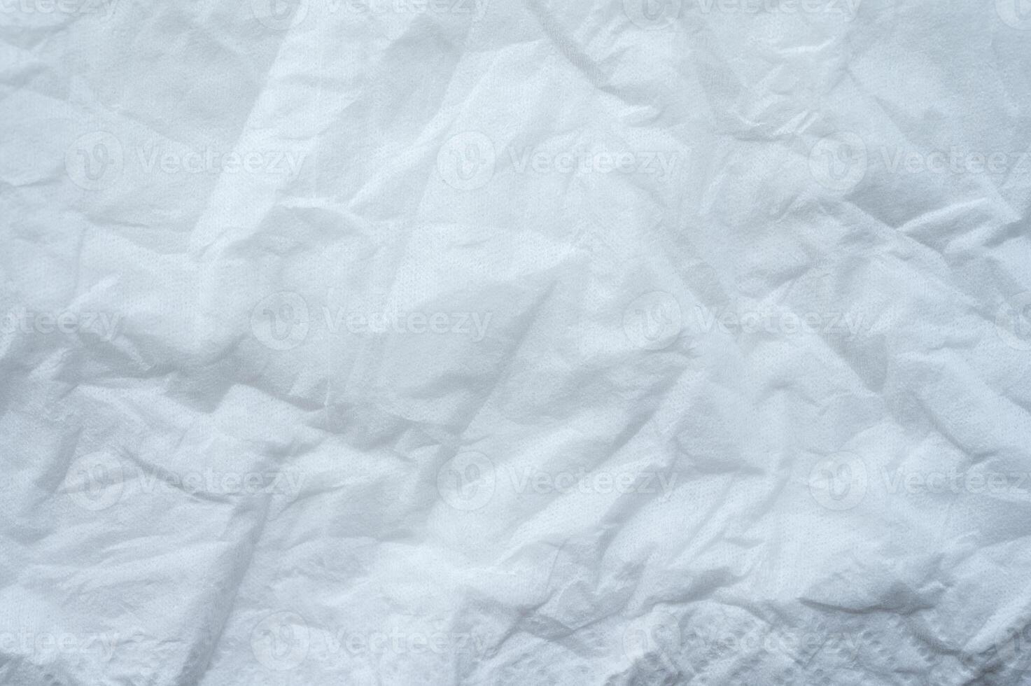 Full frame shot of crumpled tissue fabric texture and background. Tissue fabric is slightly rough and crisp in texture. photo
