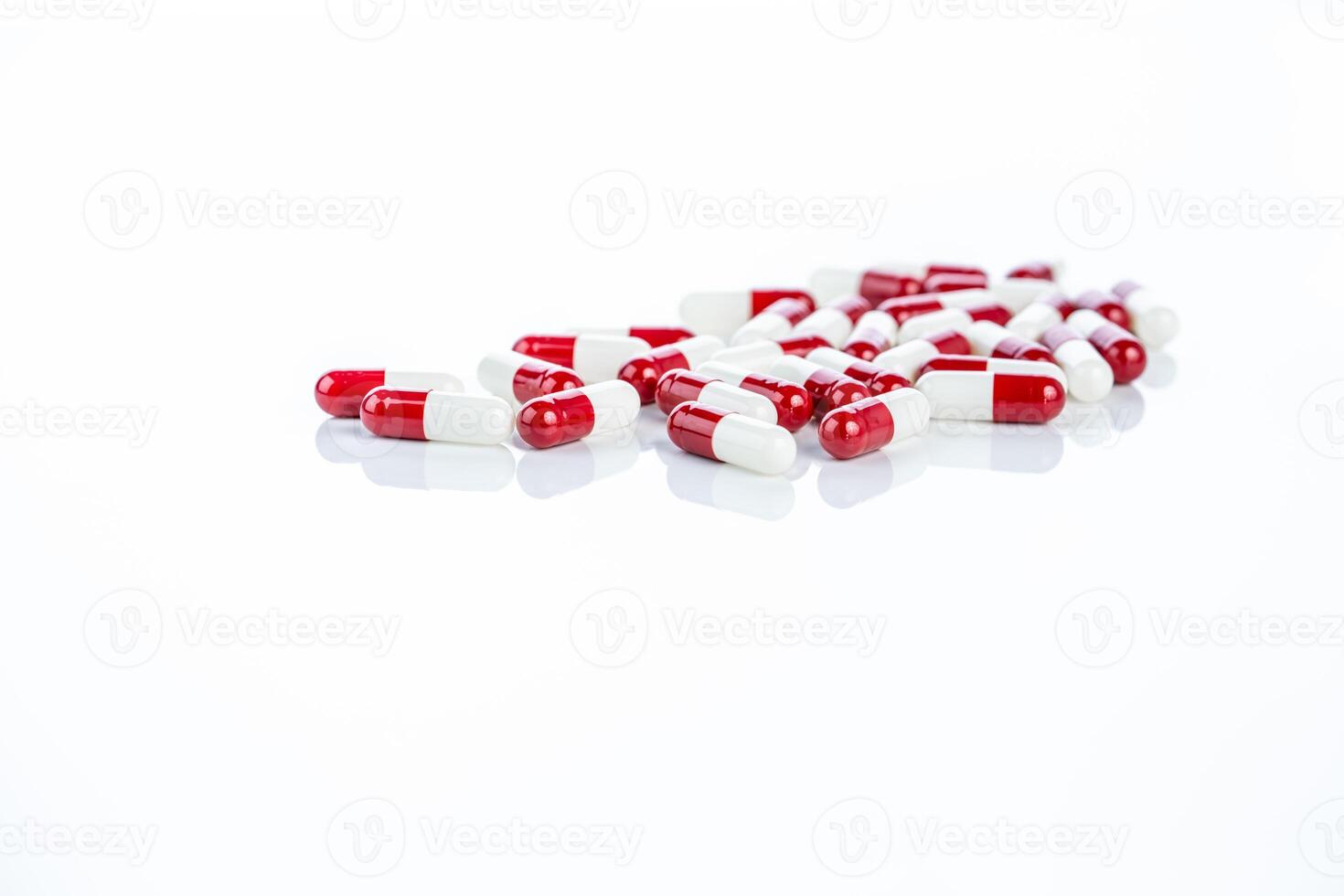 Close-up of capsule pills on a clean white surface. Pharmaceutical products, healthcare concepts, and the significance of prescription drugs in treating illness and improving patient care. photo