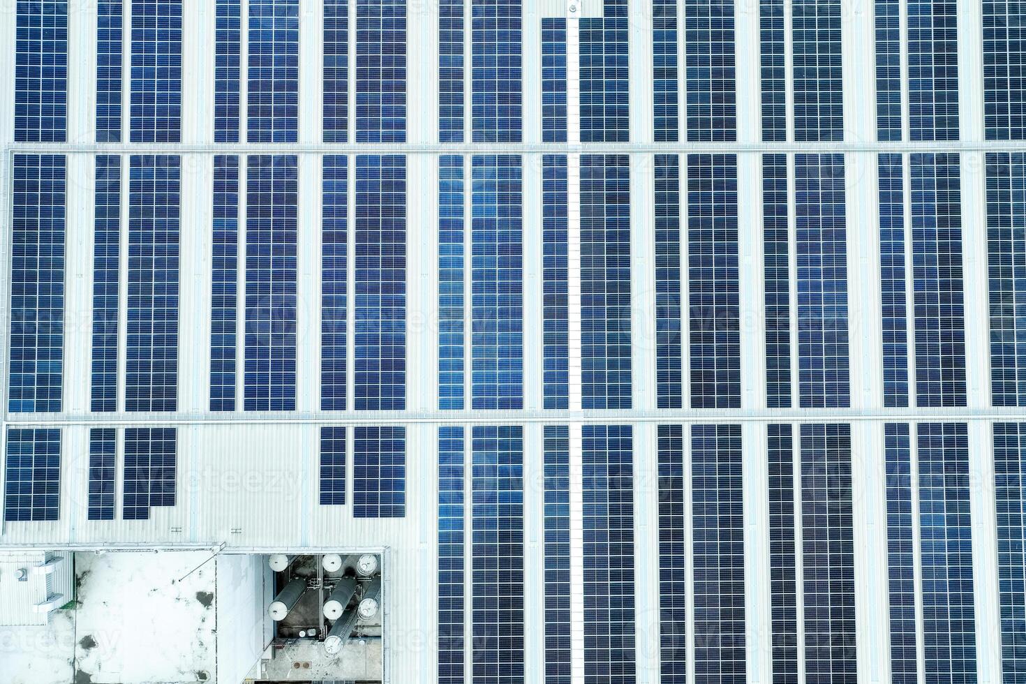 Solar energy for factory and warehouse building. Solar panels on roof of industrial plant. Commercial solar power. Rooftop solar power. Rooftop renewable energy. Sustainable energy. photo