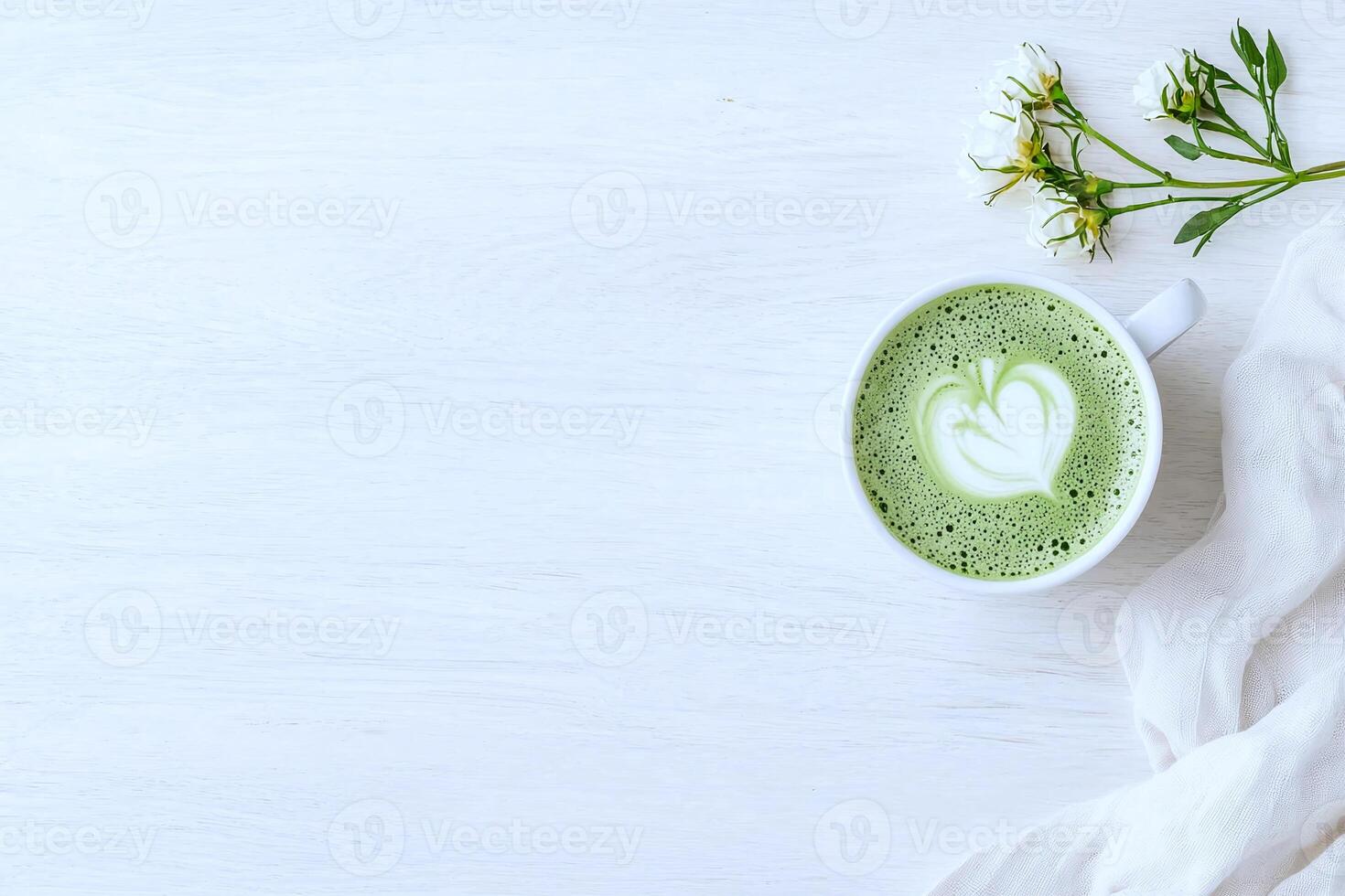 Cup of matcha tea with a flower on a wooden table, viewed from above, serene and minimalist photo