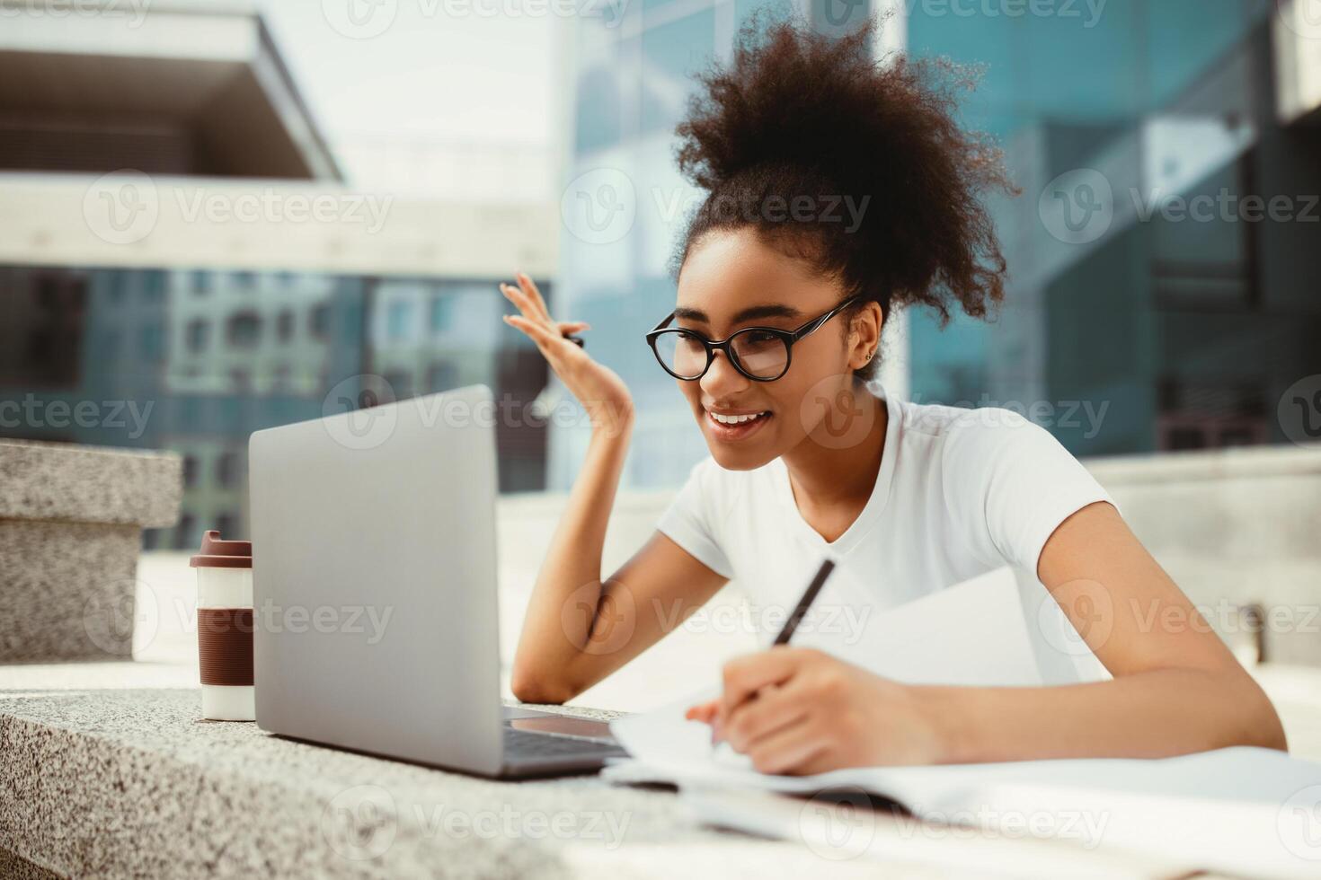 Online Learning. African American College Girl Using Laptop And Writing Taking Notes Watching Virtual Lecture Sitting Outdoors In Modern University Campus. Remote Study, E-Learning Concept photo