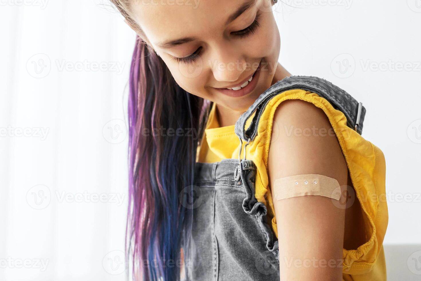 Healthcare And Inoculation Concept. Portrait Of Smiling Teen Patient Showing Vaccinated Arm With Plaster On Shoulder After Coronavirus Vaccination, Looking At Hand. Antiviral Vaccine, Banner, Panorama photo