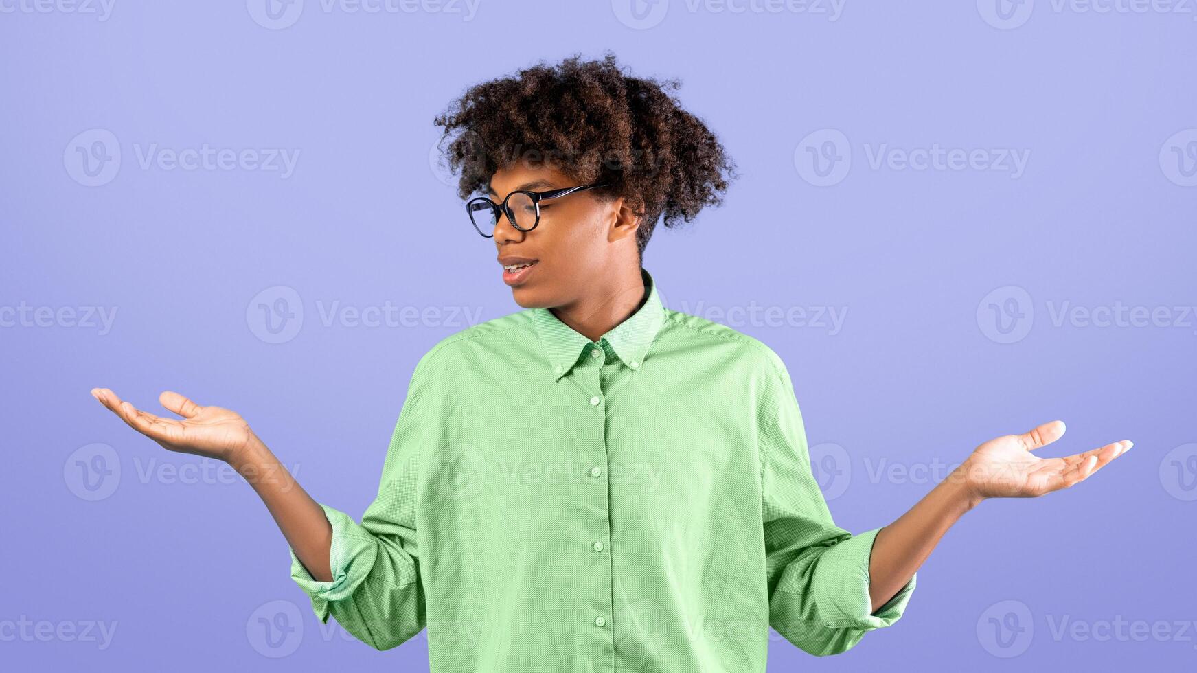 Make best decision. African american guy making scales with his empty hands, comparing options standing over blue studio background, copy space photo