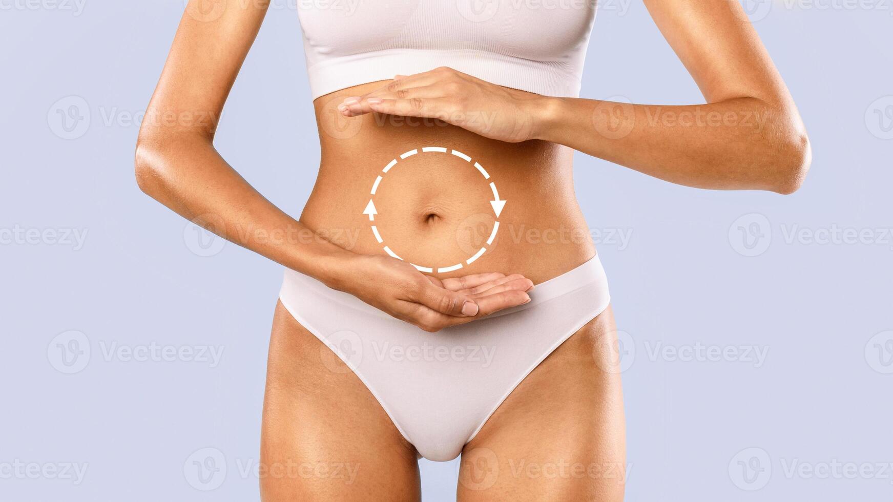 Closeup cropped view of woman holding hands near belly presenting empty free space for product advert, measuring invisible item, female palms making gesture showing big amount or size at blue studio photo