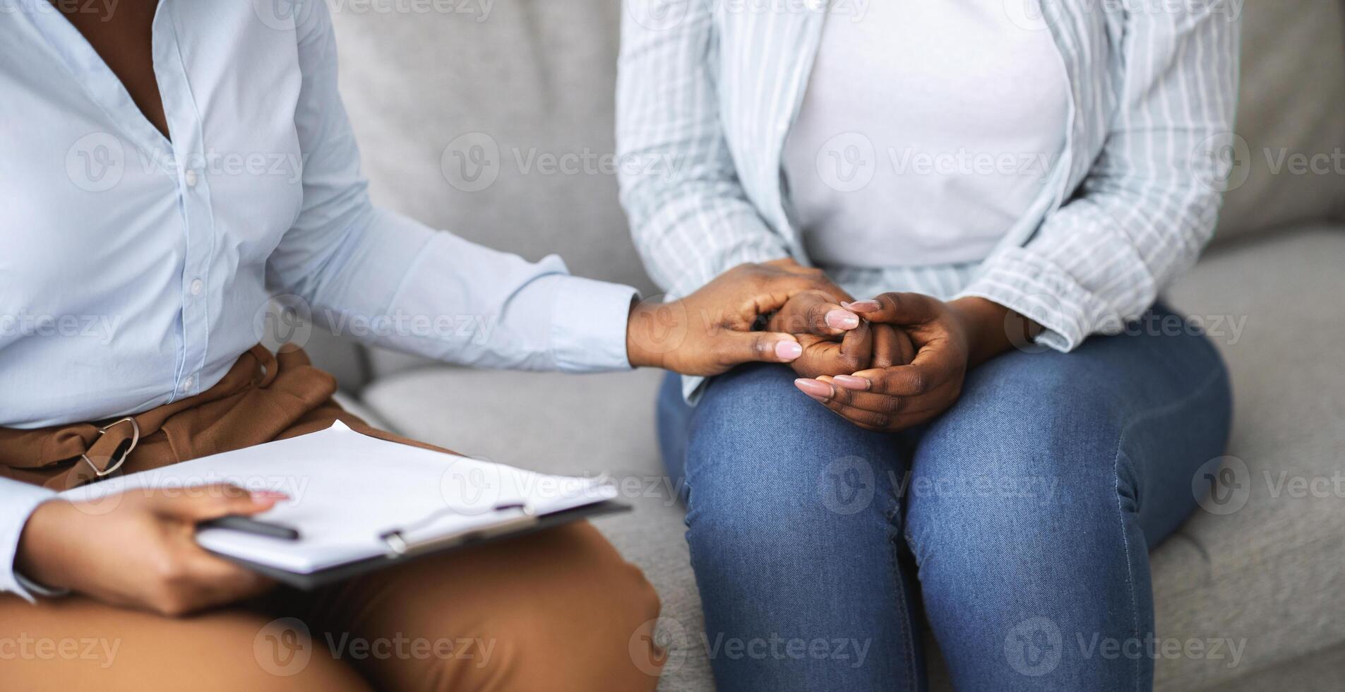 Professional help for people with depression. Therapist providing psychological assistance to female patient, holding her hand at clinic, cropped view. Treatment of emotional and mental disorders photo
