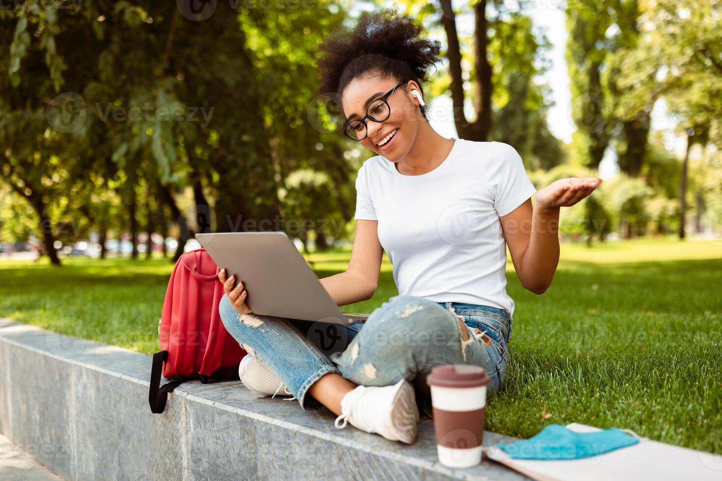 E-Learning. Happy American American Student Girl Using Laptop Making Call Having Distance Virtual Lecture Learning Online Sitting Outside. Remote College Education. Technology And Studentship photo