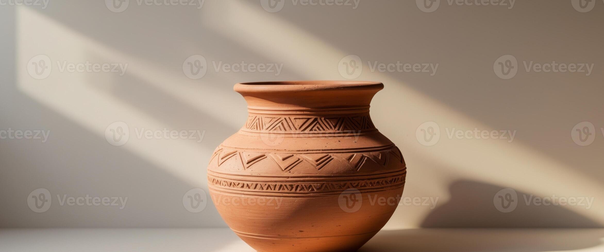 Intricate Terracotta Vessel with Tribal Design photo