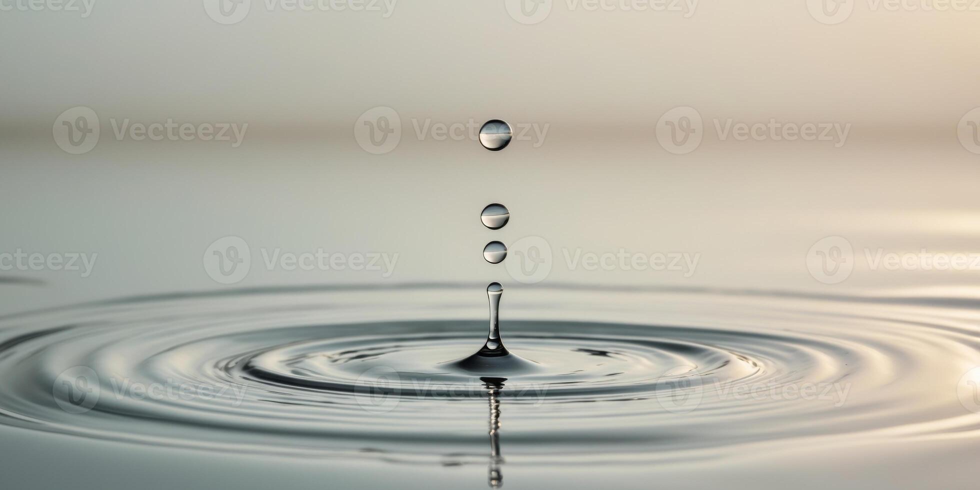 a water droplet falling into a water surface photo