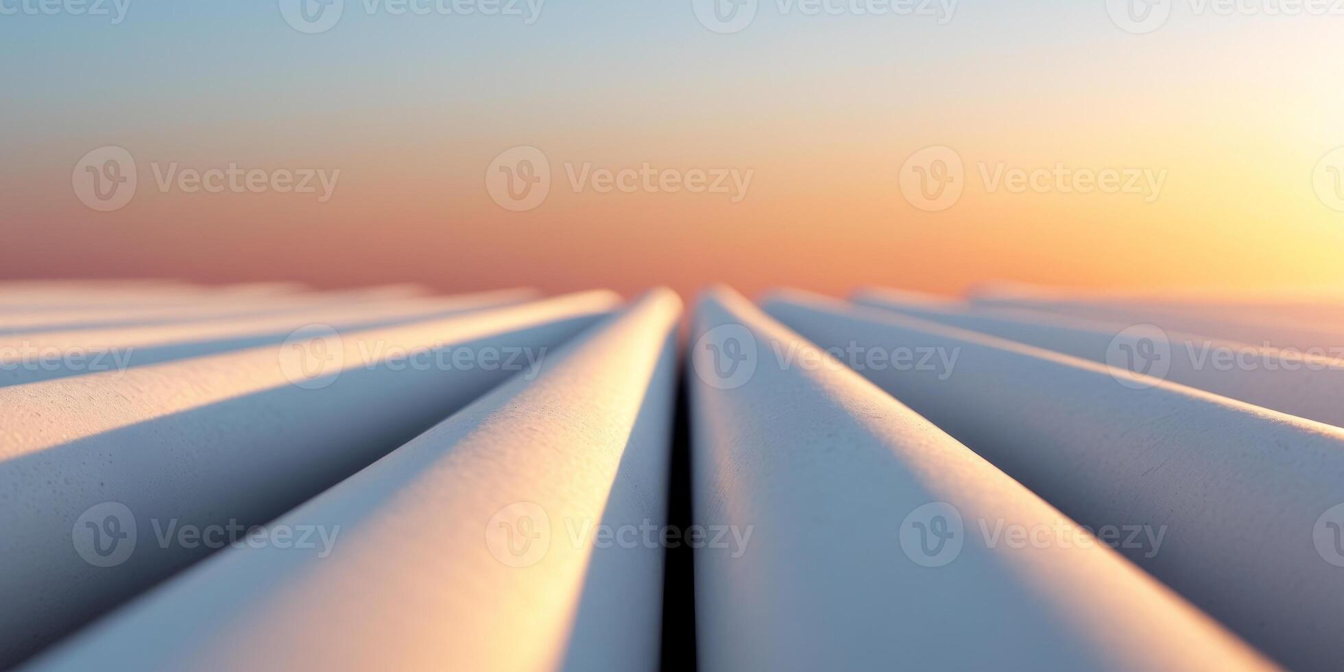 Cylindrical shapes receding to a bright sunset with a sky of orange and blue hues. photo