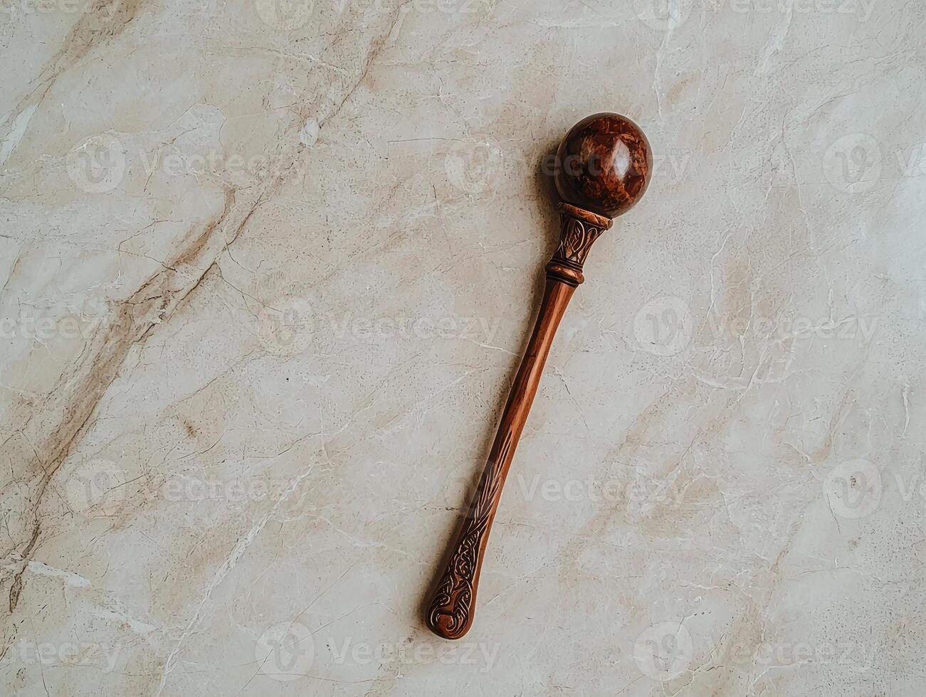 Ornate wooden ceremonial mallet on marble background photo