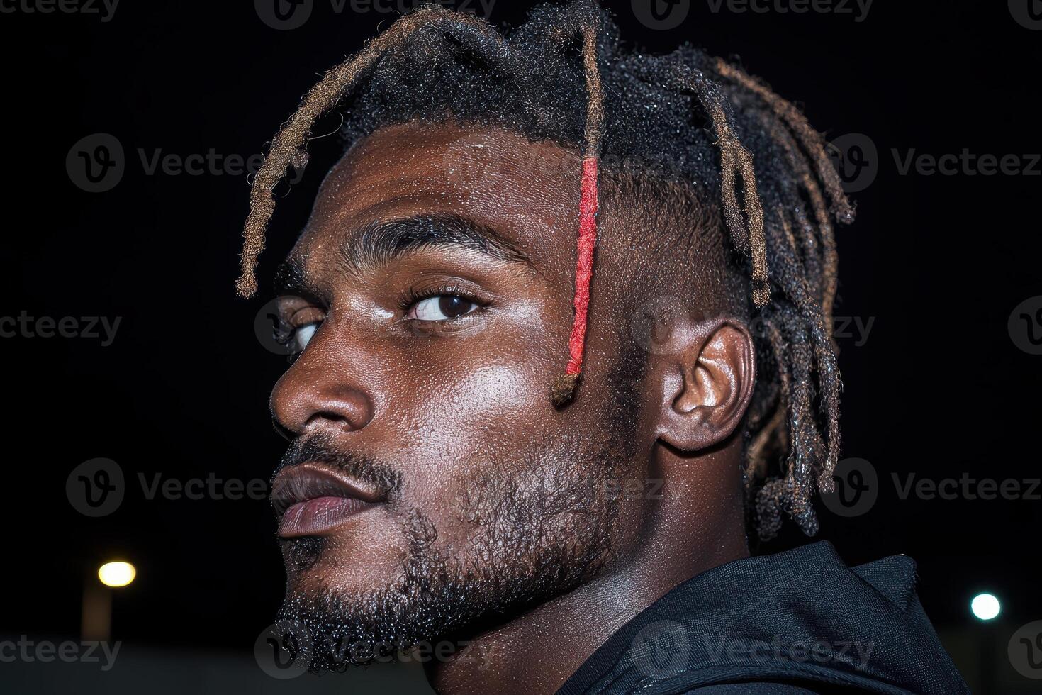 Close up portrait of a young man with dreadlocks photo