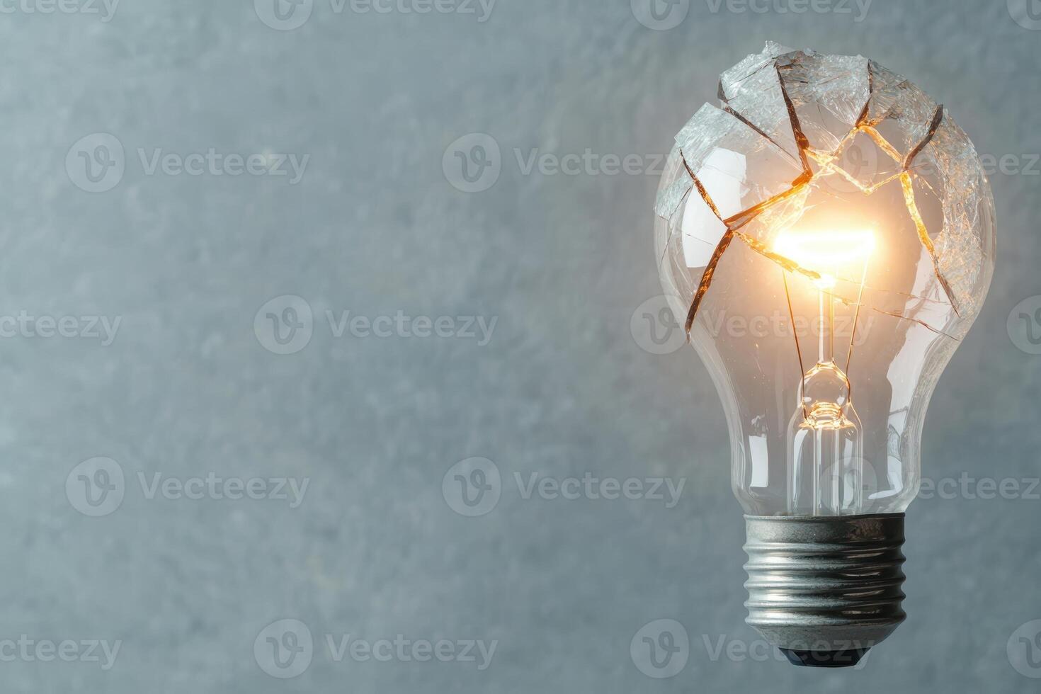 Broken light bulb still shining brightly photo