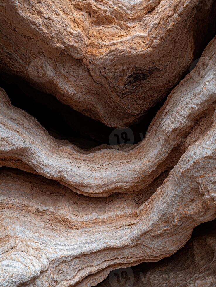 Abstract rock formation with wavy layers and textures photo