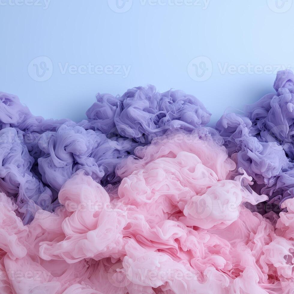 Abstract pastel pink and purple ink swirling in water photo
