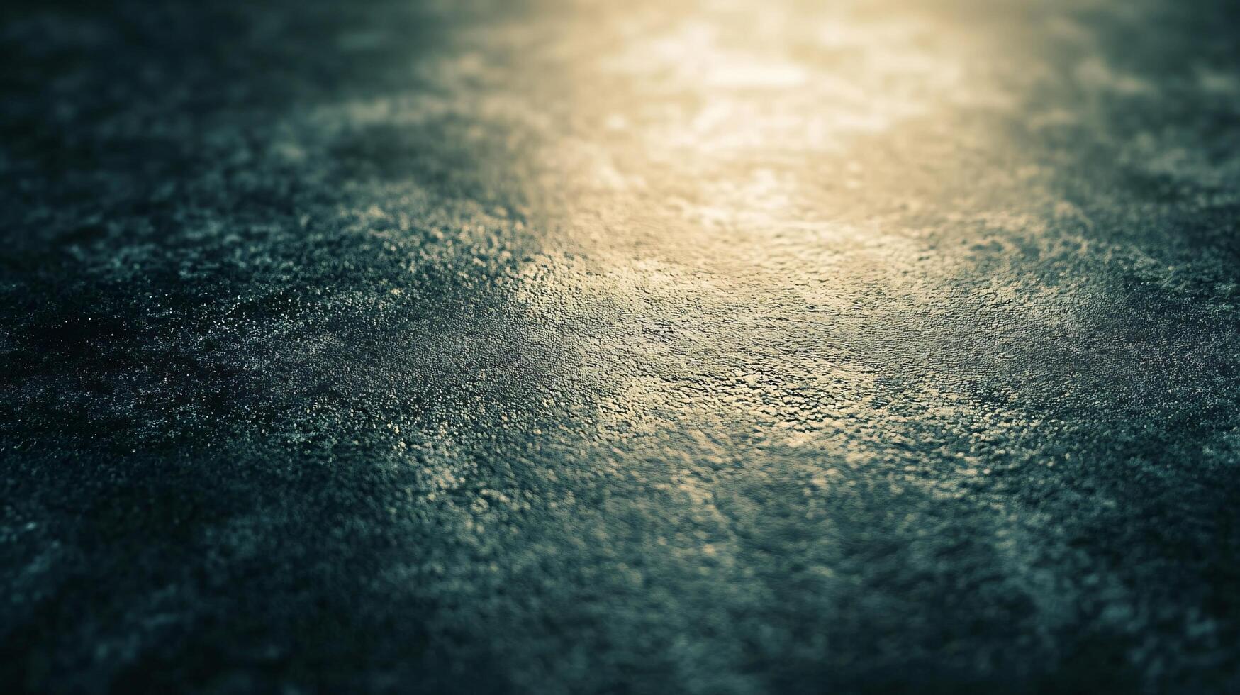 A blurry image of a wet surface with a dark blue background photo