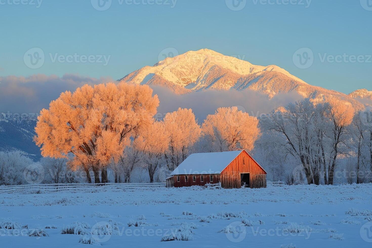 Red barn illuminating at sunrise in a frosty winter landscape photo