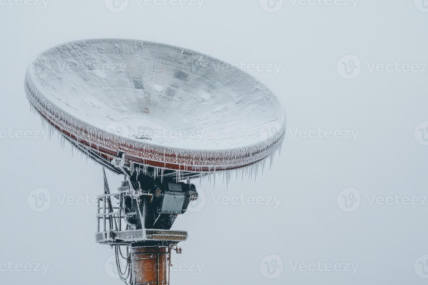 Frozen satellite dish enduring winter weather conditions photo