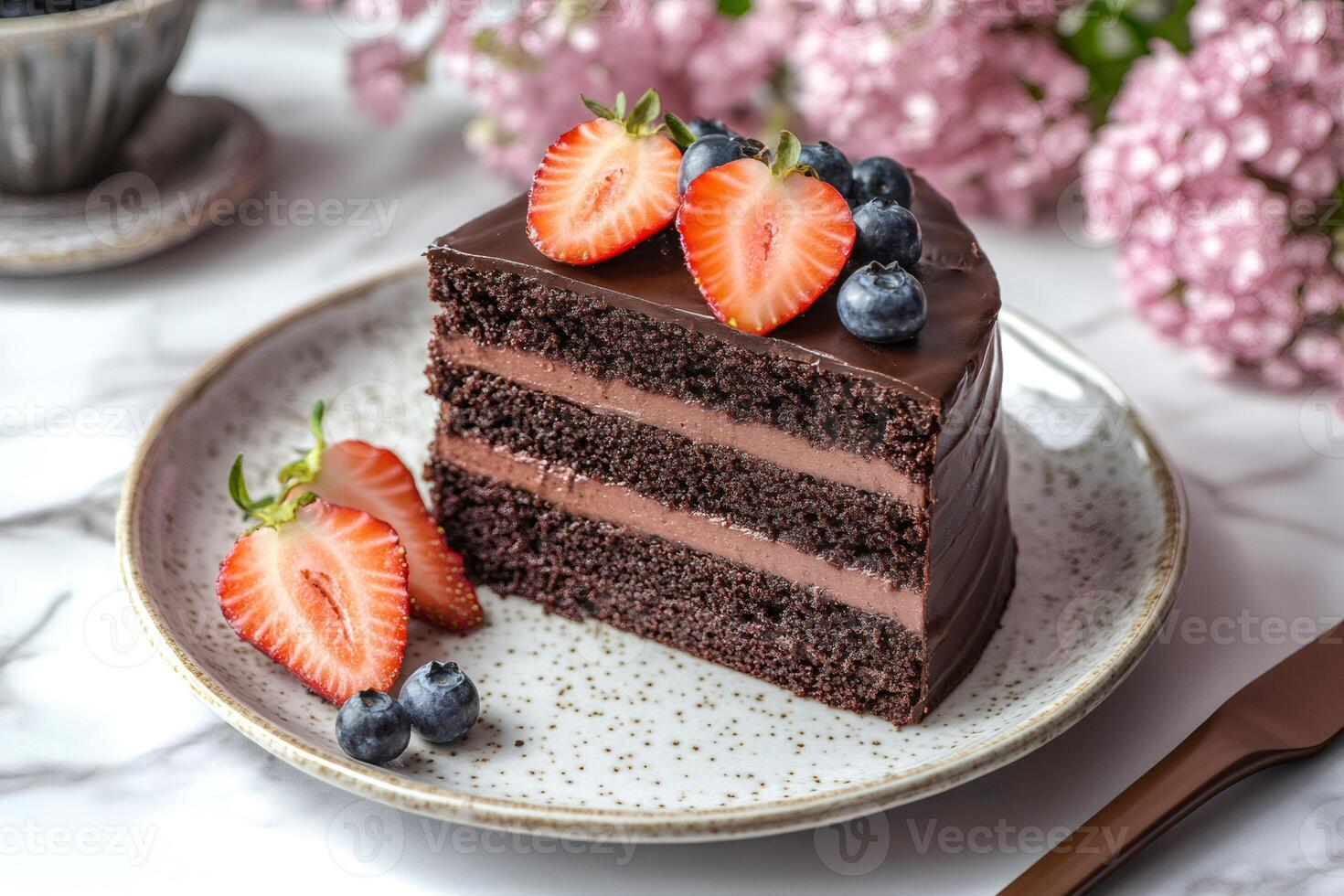 Delicious chocolate cake slice with fresh berries and chocolate frosting photo